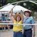 Susan Hamady and her husband Jon Holtfreter, work together to construct the frame of Hamady's tent during set up for the Ann Arbor Art Fair on Tuesday, July 16, 2013. Melanie Maxwell | AnnArbor.com